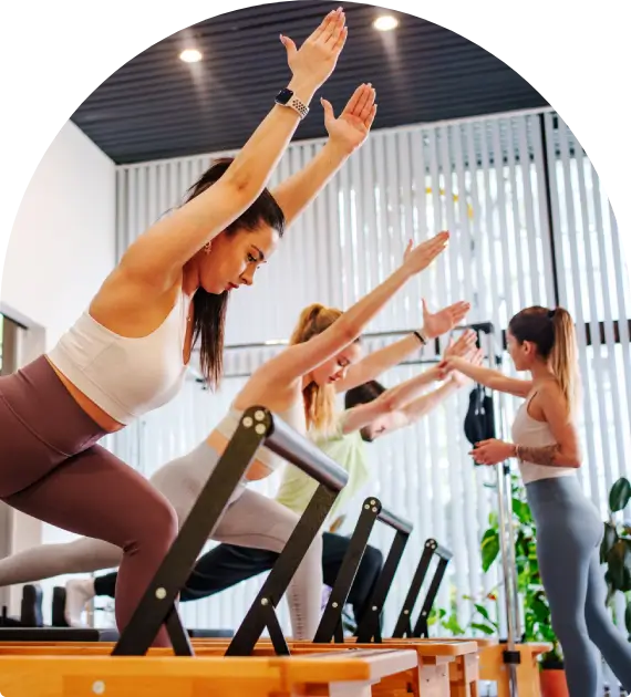 Group fitness class performing chair-based exercises with instructor guidance.
